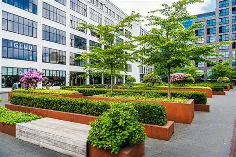 trees and flowers in front of an office building